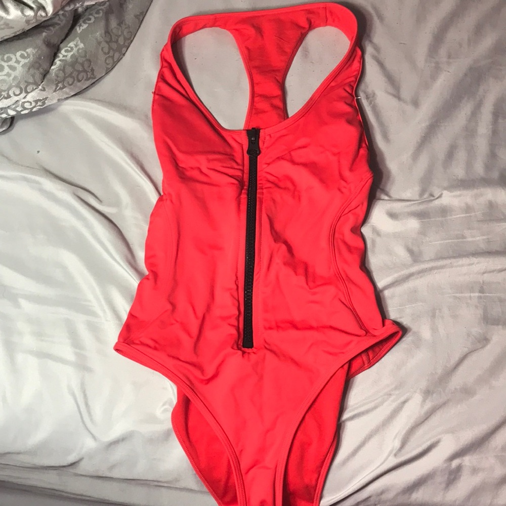 Orangish red bathing suit zips and is padded